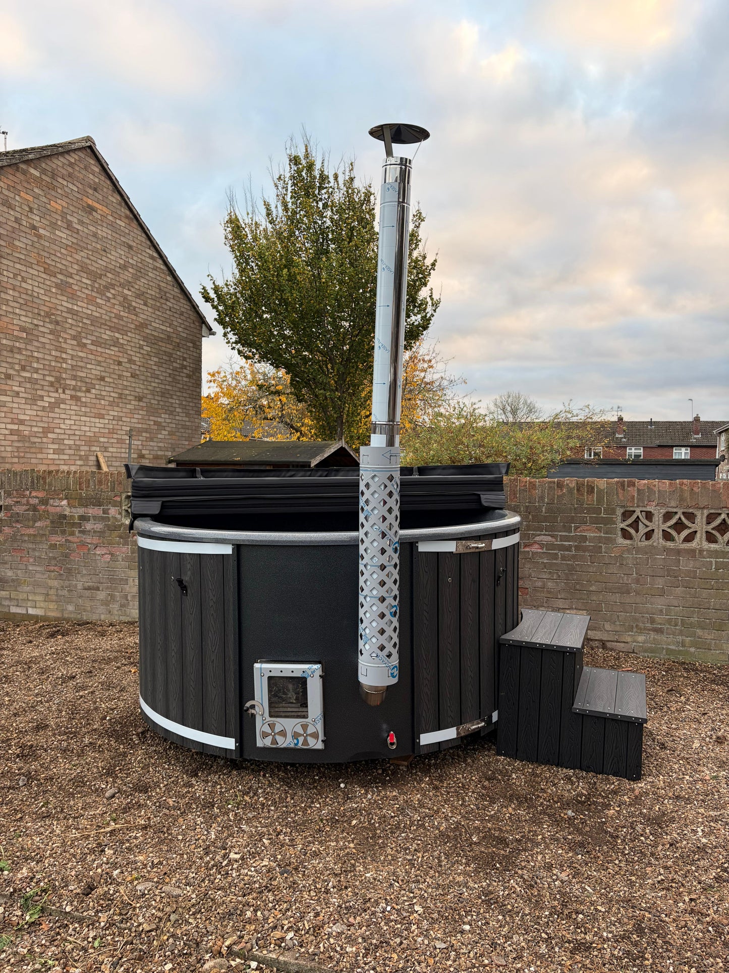 Round Wood-Fired Hot Tub with Integrated Log Burner