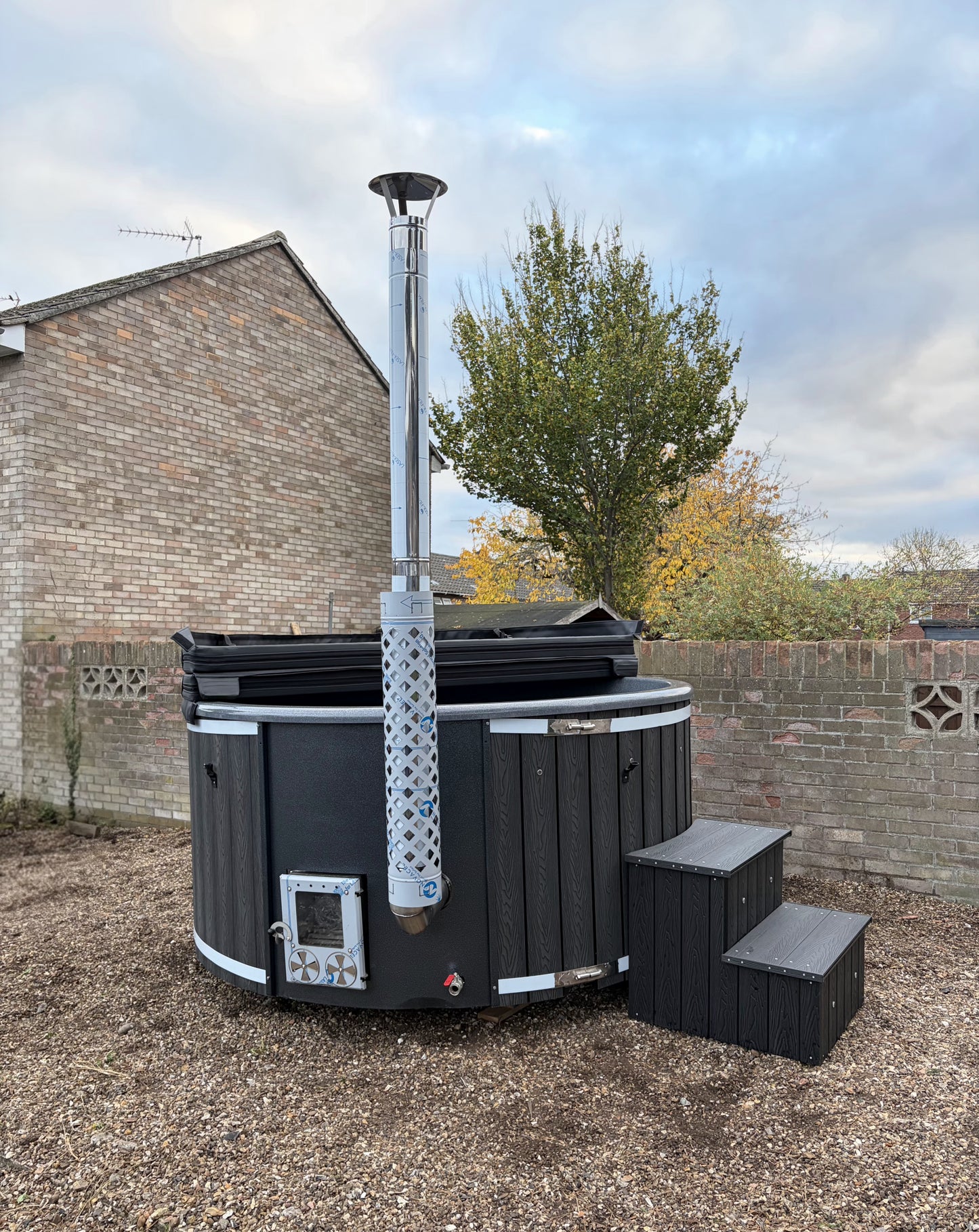 Round Wood-Fired Hot Tub with Integrated Log Burner
