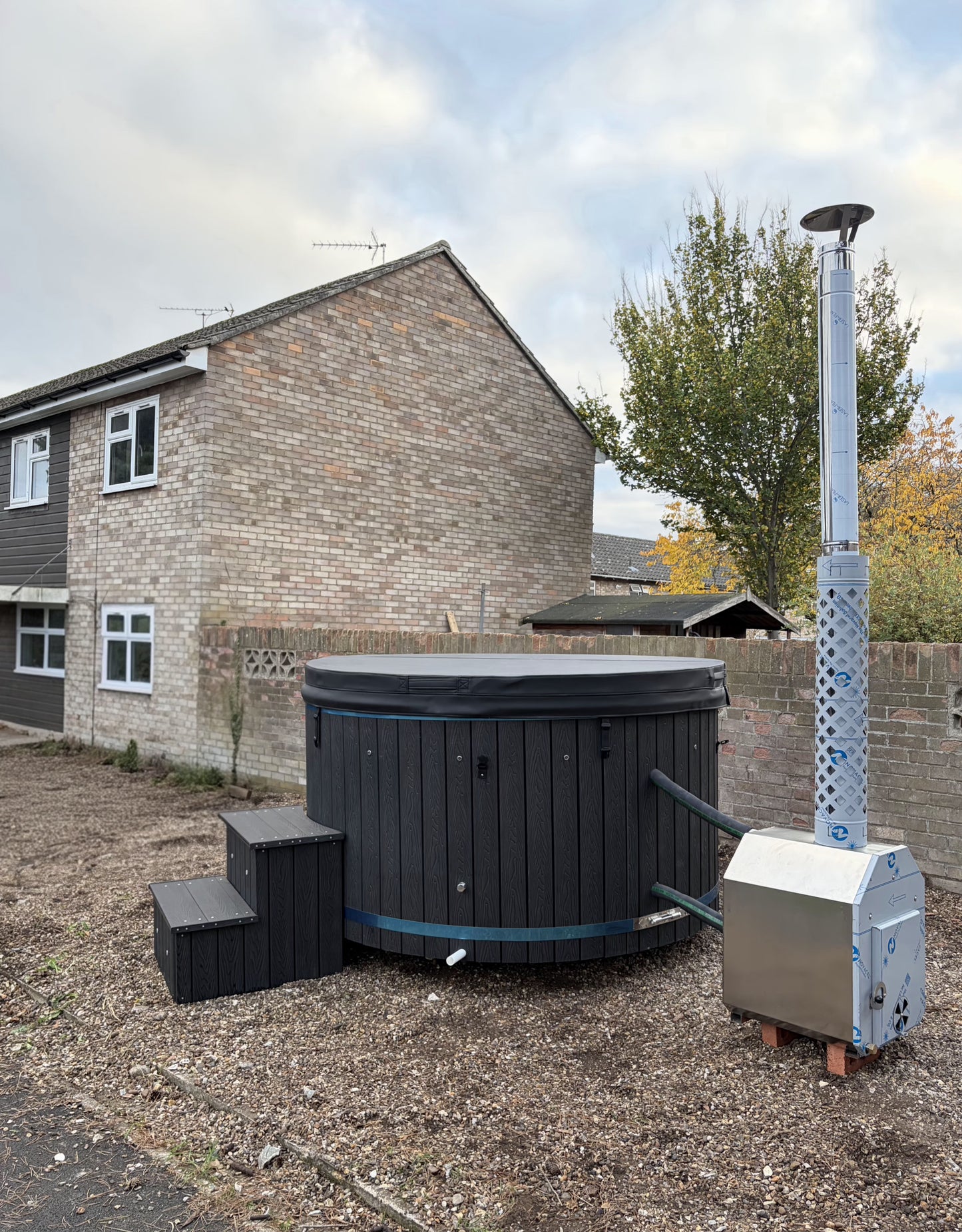 Round Wood-Fired Hot Tub with External Log Burner