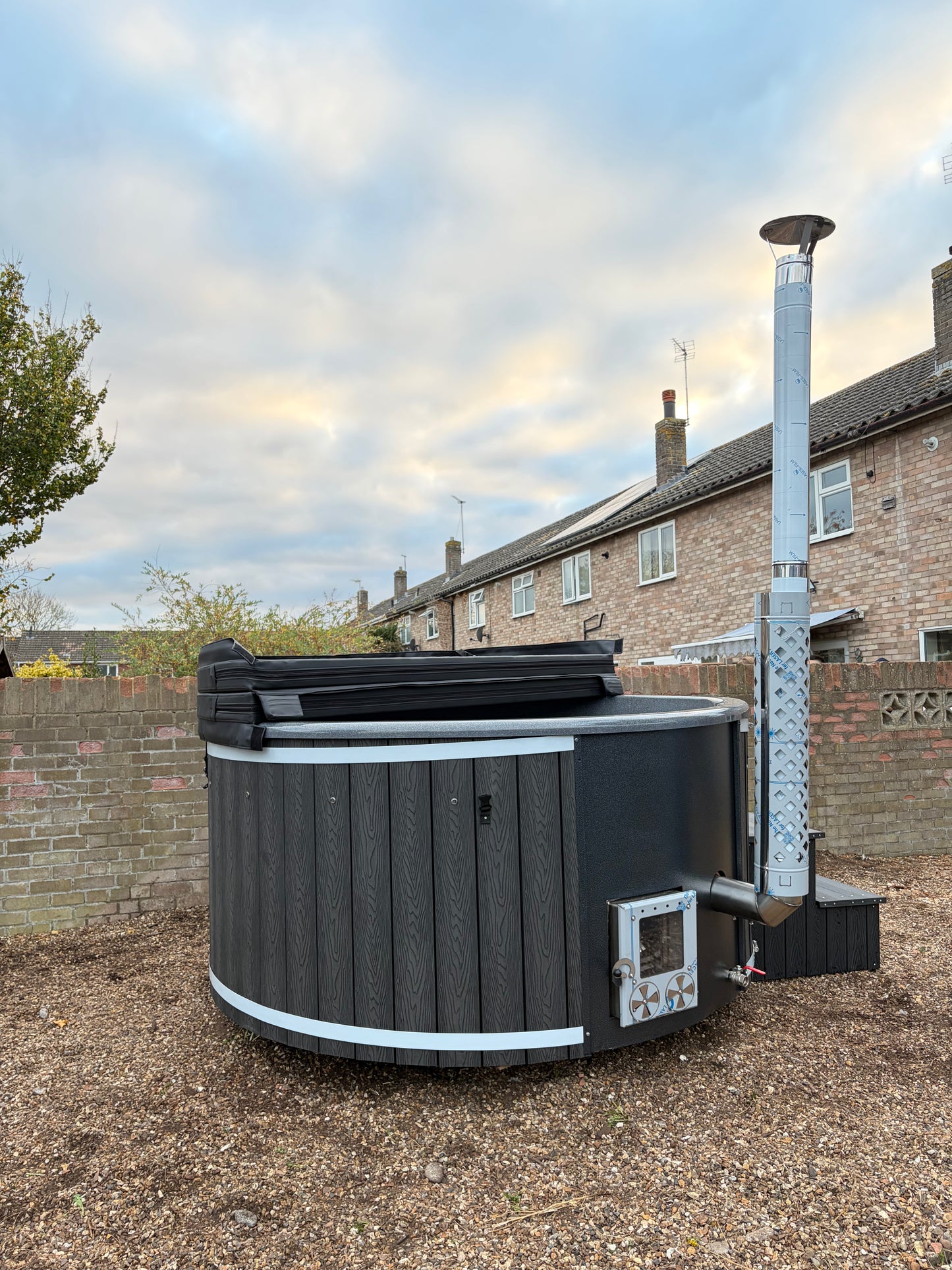 Round Wood-Fired Hot Tub with Integrated Log Burner